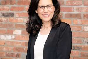 Carol fishman cohen heashot brick background