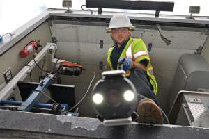 Jake Zeiger Prepares To Lower An Inspection Camera Into A Manhole