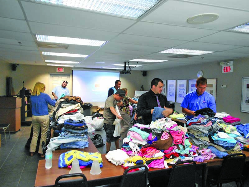 Vac-Con employees collect clothing, school supplies